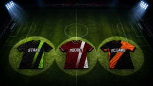 Three soccer jerseys on a stadium pitch representing Stake, Roobet, and BC.Game, illustrating a comparison of the three iGaming brands' online reputations.