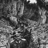 Telegram avatar for NiksGambles: a black-and-white historical photograph of several men in vintage military uniforms and peaked caps walking through a trench.